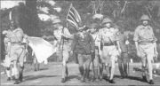 Lieutenant-General Percival led by a Japanese officer, marches under a flag of truce to negotiate the capitulation of Allied forces in Singapore, on 15 February 1942. It was the largest surrender of British-led forces in history