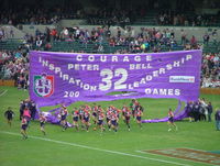 Before the start of each AFL games, players run through a banner constructed by supporters.