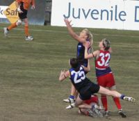 A Female Australian Rules Football Match beetween the Melbourne University Mugars and the Darebin Falcons.