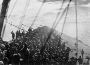 The crew of Zuikaku salute as the flag is lowered, and the Zuikaku ceases to be the flagship of the Japanese Navy.