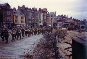 U.S. soldiers march through Weymouth, a southern English coastal town, en route to board landing ships for the invasion of France.