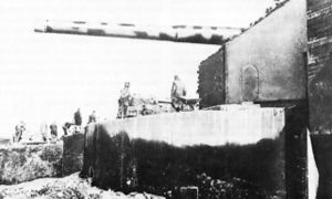 German coastal artillery in the Pas-de-Calais area, with laborers at work on casemate.