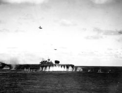 A damaged Japanese Val dive bomber (upper left) purposely dives towards Hornet at 09:13...