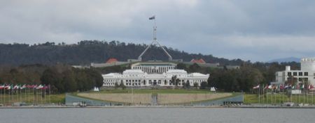 Two of Canberra's best-known landmarks, Parliament House and Old Parliament House (foreground). Commonwealth Place runs alongside the lake and includes the International Flag Display