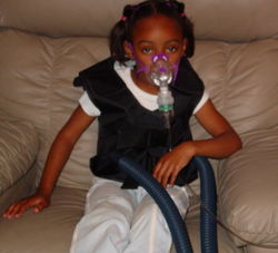 A typical breathing treatment for cystic fibrosis, using a mask nebulizer and the ThAIRapy Vest