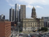 A view looking south down Brush Street at the Renaissance Center (rear left) and the Wayne County Building (right). The giant decal on the Renaissance Center was installed for the 2005 MLB All-Star Game. It is 4,612 feet (1,375 m) from the home plate in Comerica Park to the main tower of the Renaissance Center