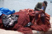 A Moroccan fisherman mending his nets.