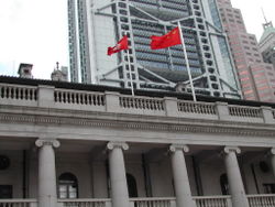 The HKSAR and the PRC flags brandishing at the patio of the Legislative Council. It is a common routine to fly the regional flag left to the national flag in the open air.