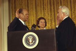 Vice President Ford is sworn in as the 38th President of the United States by Chief Justice Warren Burger as Mrs. Ford looks on.