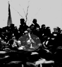 The only known photo of Abraham Lincoln at Gettysburg (seated, center), taken about noon, just after Lincoln arrived and some three hours before he spoke. To Lincoln's right is his bodyguard, Ward Hill Lamon.
