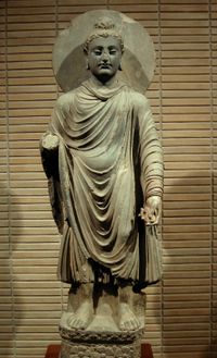 The Buddha, in Greco-Buddhist style, 1st-2nd century CE, Gandhara. (Standing Buddha (Tokyo National Museum)).