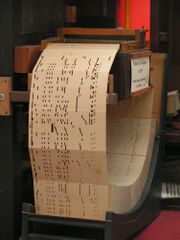 Punch card system of a music machine. Also referred to as Book music, a one-stop European medium for organs