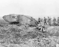 Canadian soldiers advance behind a tank at the Battle of Vimy Ridge in 1917.