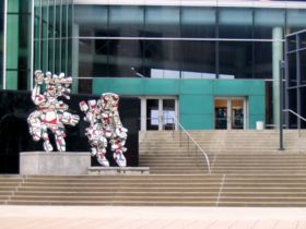 The statues "Faribolus and Perceval," by Jean Dubuffet, stand at the entrance to the Kentucky Center.