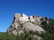 Mt Rushmore, showing full size of mountain and the scree of debris from construction.