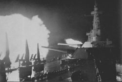 Washington fires upon Japanese battleship Kirishima during the battle on November 14-15, 1942.  The low elevation of the gun barrels is due to the relatively close range of the two adversaries.