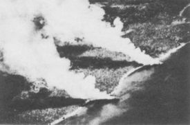 Two Japanese transports beached on Guadalcanal and burning on November 15, 1942