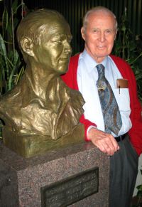Norman Borlaug with his bust in the University of Minnesota's Borlaug Hall, October 2003.