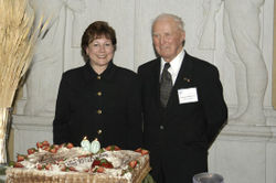 Dr. Borlaug with USDA Agriculture Secretary Ann M. Veneman near the birthday cake prepared for his 90th birthday
