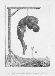 An engraving by William Blake illustrating "A negro hung by his ribs from a gallows," from Captain John Stedman's Narrative of a Five Years Expedition Against the Revolted Negroes of Surinam, 1792. The hanging took place in the then-Dutch ruled Surinam, an example of the barbarity of punishments of slaves, and the reputation of Surinam.