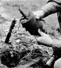 An American paratrooper demonstrates the process of removing a live S-mine