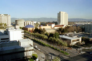 Downtown San Jose looking over the Tech Museum towards Mount Hamilton; hills in the background show their winter green color.