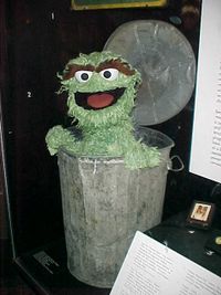 An Oscar the Grouch puppet (shown) and Sesame Street sign both reside in the Smithsonian National Museum of American History.