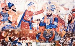 Baba Buddha places a tikka (a mark of distinction) on the forehead of Guru Arjun Dev, pronouncing him the fifth Guru. Guru Ram Das is seated on the right.