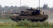 An M1 Abrams tank on lookout. Heat haze from the turbine engine can be seen to the rear.