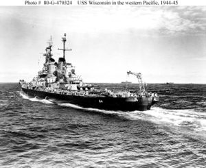 Wisconsin escorting US Essex-class aircraft carriers in the Pacific Ocean during World War II. The tail crane was used to recover reconnaissance planes launched by Wisconsin.