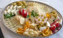 A cheese platter with many types of cheese.