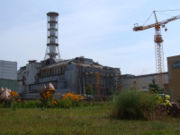 The completed (but crumbling) sarcophagus surrounding Chernobyl reactor 4, viewed from the northwest.