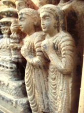 Detail of the couple of devotees, in profile.