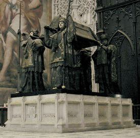 Columbus' tomb in the cathedral of Seville. It is borne by four statues of kings representing the Kingdoms of Castile, Leon, Aragon, and Navarre.