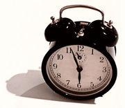 A windup, mechanical, spring-driven alarm clock.