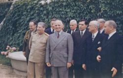 Harry S. Truman and Joseph Stalin meeting at the Potsdam Conference on July 18, 1945. From left to right, first row: Stalin, Truman, Soviet Ambassador Andrei Gromyko, Secretary of State James F. Byrnes, and Soviet Foreign Minister Vyacheslav Molotov. Second row: Truman confidant Harry Vaughan [1], Russian interpreter Charles Bohlen, Truman naval aide James K. Vardaman, Jr., and Charles Griffith Ross (partially obscured) [2].