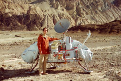 Sagan with a model of the Viking Lander probes which would land on Mars.  Sagan examined possible landing sites for Viking along with Mike Carr and Hal Masursky.