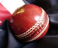 A cricket ball used in Test matches. The white stitching is known as the seam. As One-Day games are often played under floodlights, a white ball is used to aid visibility.