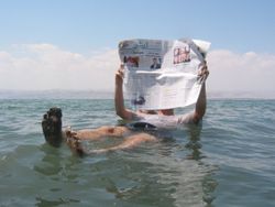 A tourist demonstrates the unusual buoyancy caused by high salinity.