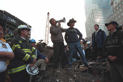 President Bush addresses rescue workers at Ground Zero in New York, September 14, 2001: "I can hear you. The rest of the world hears you. And the people who knocked these buildings down will hear all of us soon."