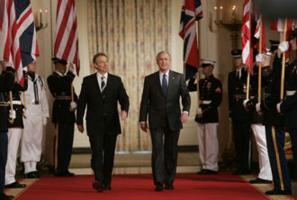 President George W. Bush traverses Cross Hall in the White House with British Prime Minister Tony Blair to attend a press conference in the East Room in 2006 discussing the Middle east Crisis between Israel and Lebanon.