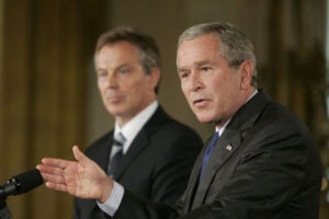 George W. Bush answering a reporter’s question during a joint press availability with Prime Minister Tony Blair in the East Room of the White House, July 28, 2006. White House photo by Paul Morse