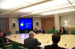 Chief Scientist of BP, Steven Koonin (top right, with computer), speaks about the energy scene in the boardroom in 2005.
