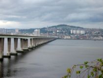 Dundee viewed across the Tay estuary from the southern side. The hill in the background is Dundee law which is situated in approximately the centre of the city. The bridge on the left is the Tay Road Bridge