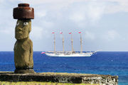Moai from Ahu Ko Te Riku in Hanga Roa, with Chilean Navy training ship Buque Escuela Esmeralda cruising behind. This moai is currently the only one with replica eyes.