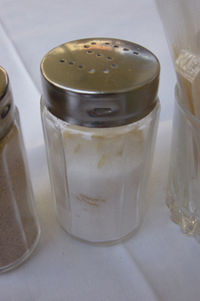 Edible salt is mostly sodium chloride (NaCl). This salt shaker also contains grains of rice, which absorb moisture and prevent the salt from caking