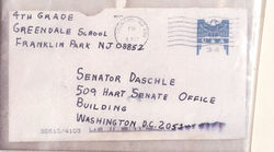 A letter sent to Senate Majority Leader Tom Daschle containing anthrax powder caused the deaths of two postal workers.