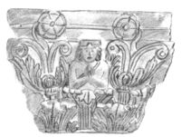 An Indo-Corinthian capital from the Butkara Stupa, representing a Buddhist devotee within foliage, dated to 20 BCE (Turin City Museum of Ancient Art).