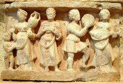 Hellenistic culture in the Indian subcontinent: Greek clothes, amphoras, wine and music (Detail of Chakhil-i-Ghoundi stupa, Hadda, Gandhara, 1st century CE).