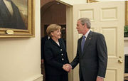 US President George W. Bush welcomes Chancellor Angela Merkel to the Oval Office